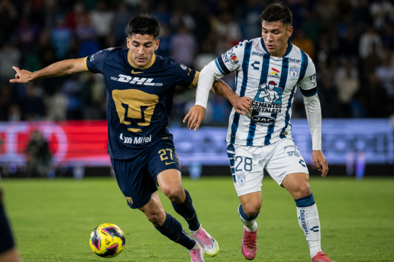 Jugadores de Pumas y Pachuca disputan el balón en un partido